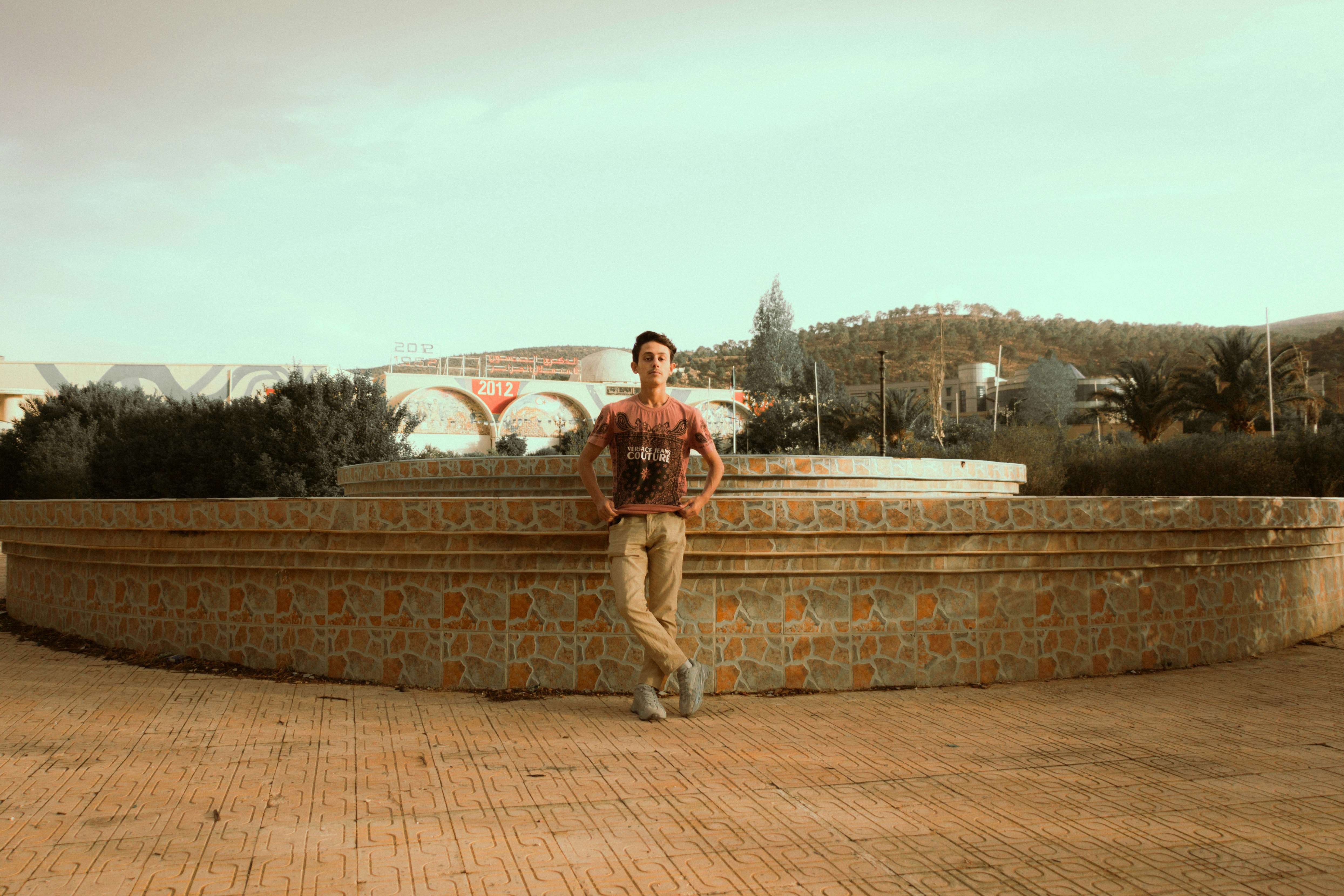 A man standing on a brick wall photo – Free Image on Unsplash