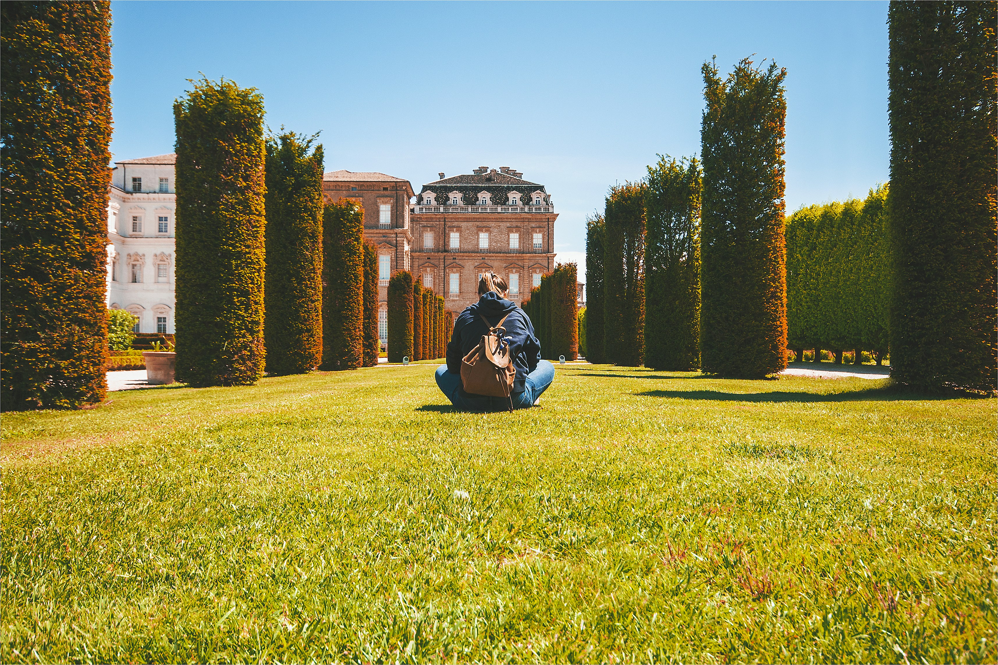 a person sitting on grass with a guitar