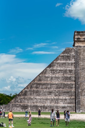 people walking around a pyramid