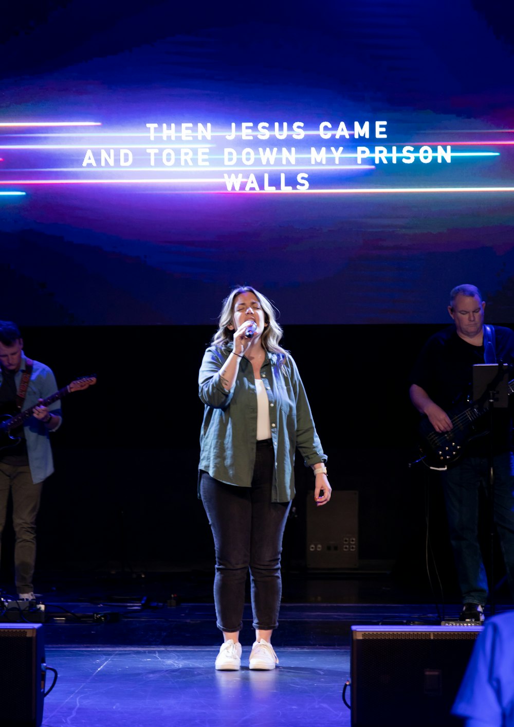 a person singing on a stage