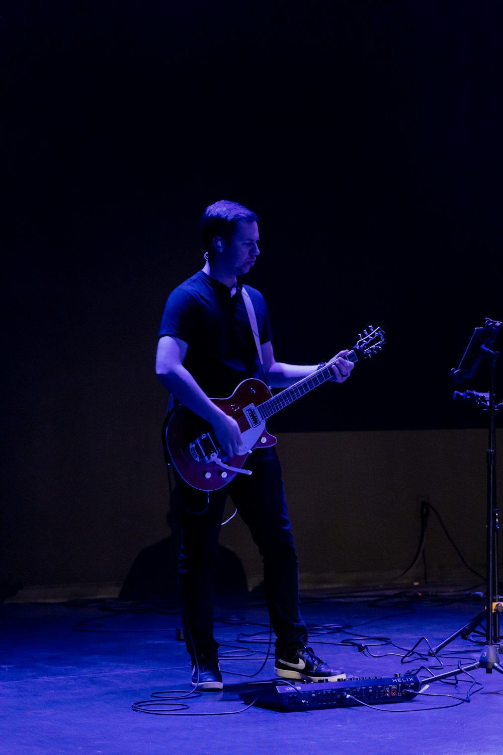 a person playing a guitar on a stage