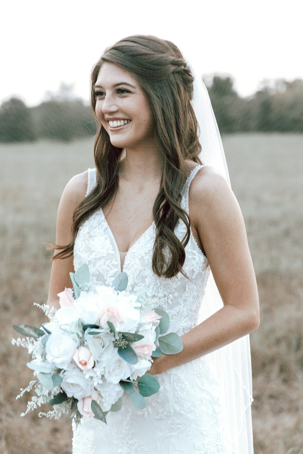 a woman in a white dress holding a bouquet of flowers