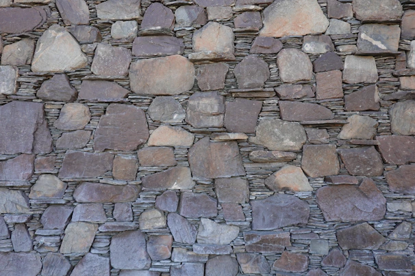 A sturdy retaining wall made of interlocking stones blending seamlessly with a Vancouver backyard
