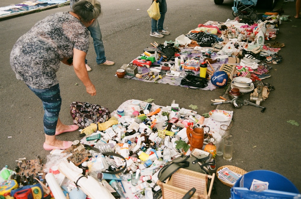 a person standing next to a pile of trash