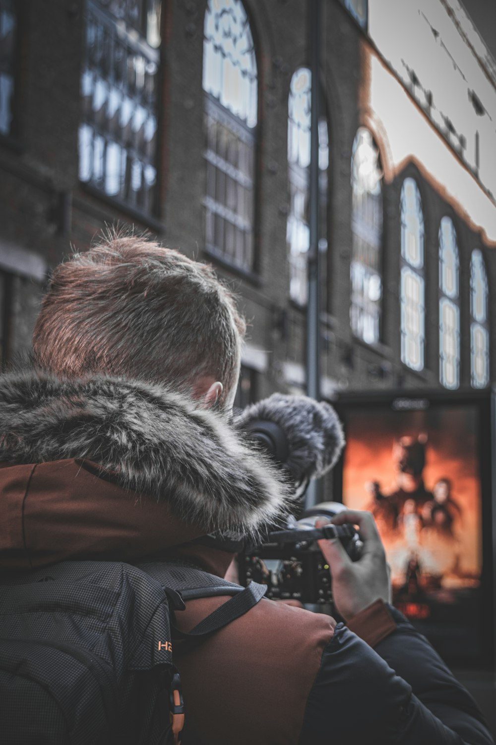 a person taking a picture of another man in a building