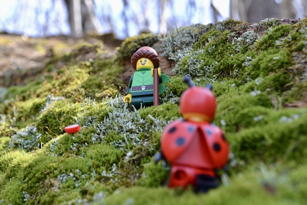 a couple of toy figures in a garden