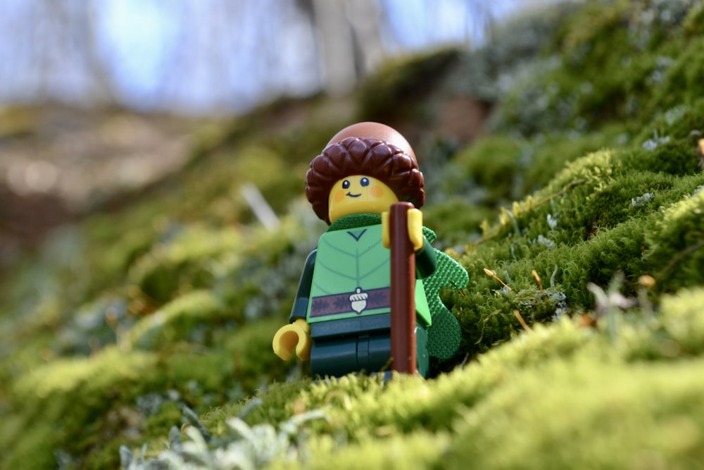 a toy figure in a garden