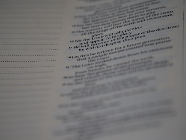 A close-up of a page from a book, featuring text in a serif font. The text appears to be of a religious or poetic nature, with some lines highlighted in bold.