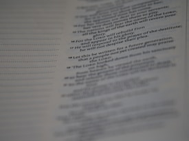 A close-up of a page from a book, featuring text in a serif font. The text appears to be of a religious or poetic nature, with some lines highlighted in bold.