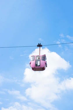 a pink car with a cable attached to it