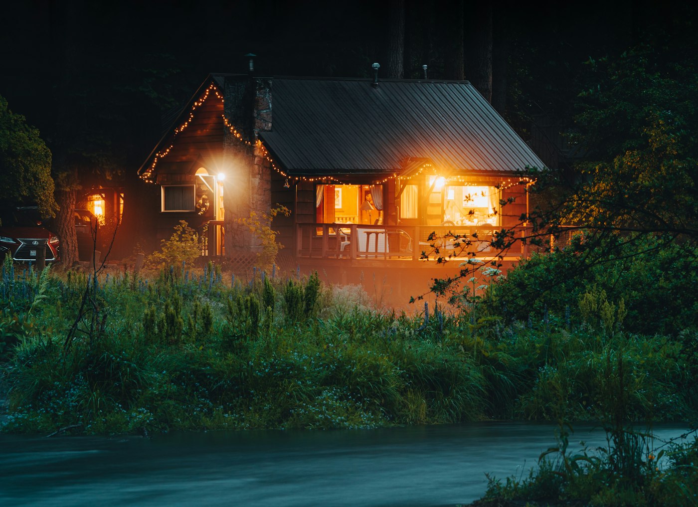 Warmly lit home at dusk in Camp Sherman, Central Oregon