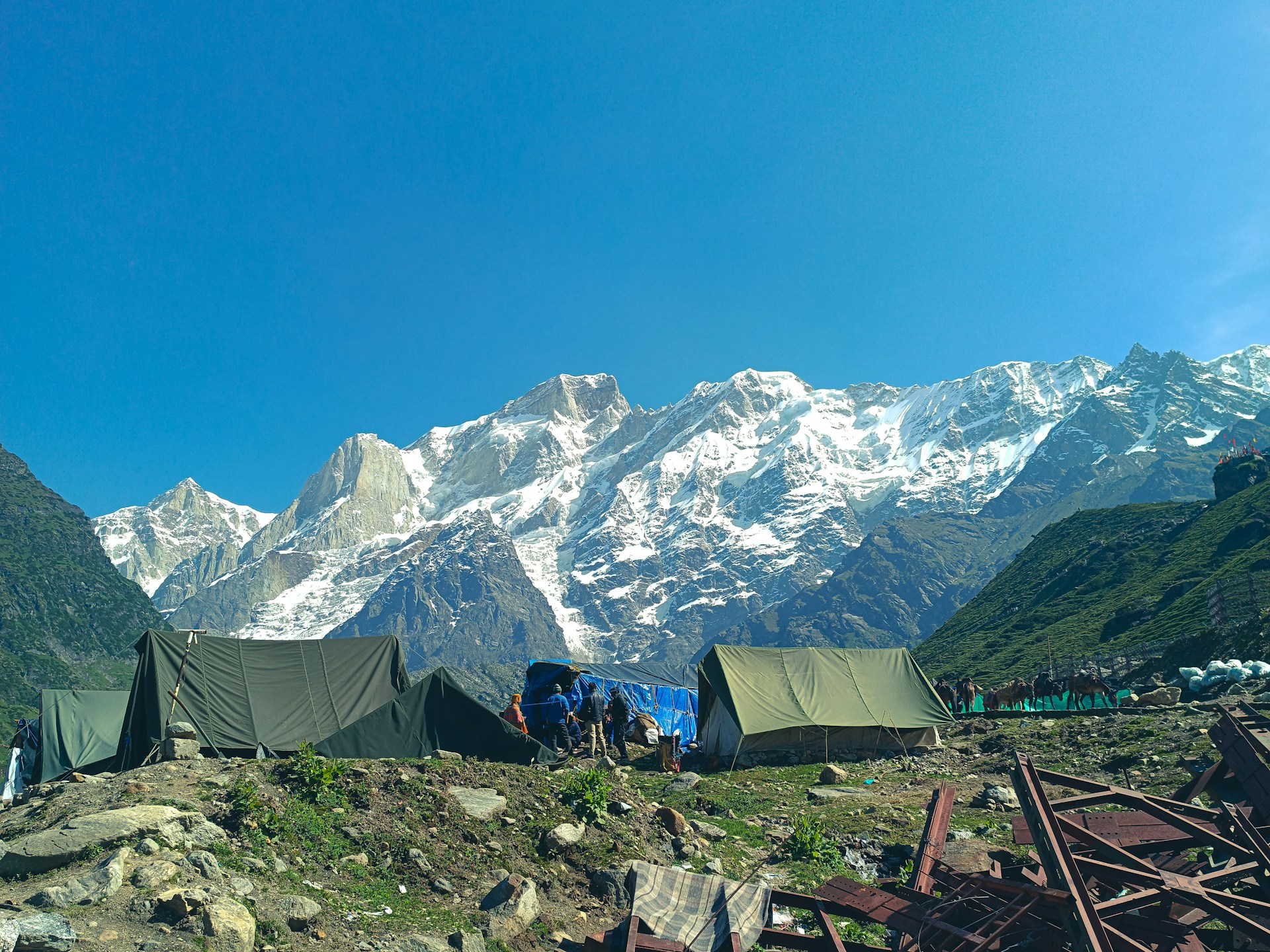 tents in a field with mountains in the background