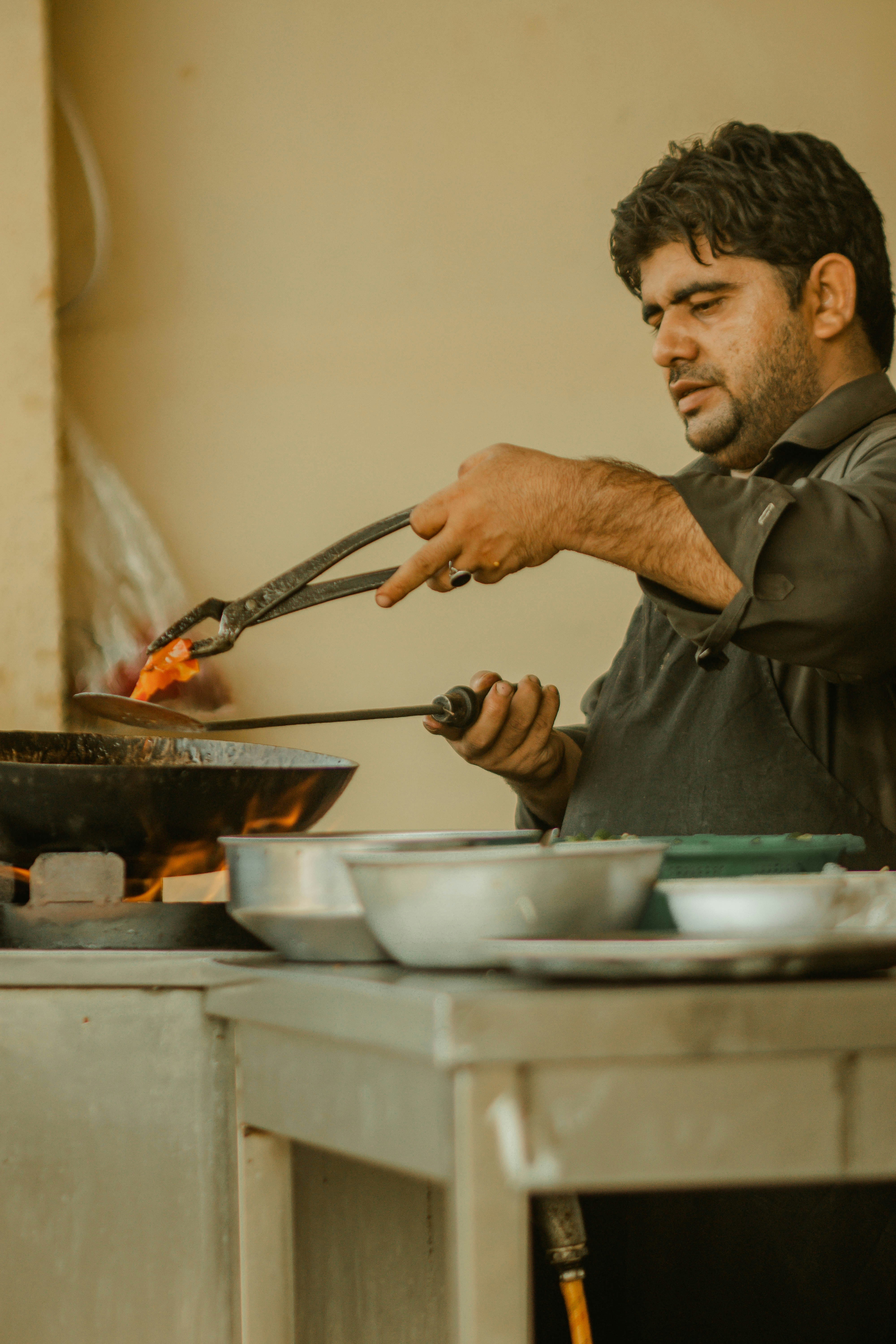 a man cooking food in a kitchen
