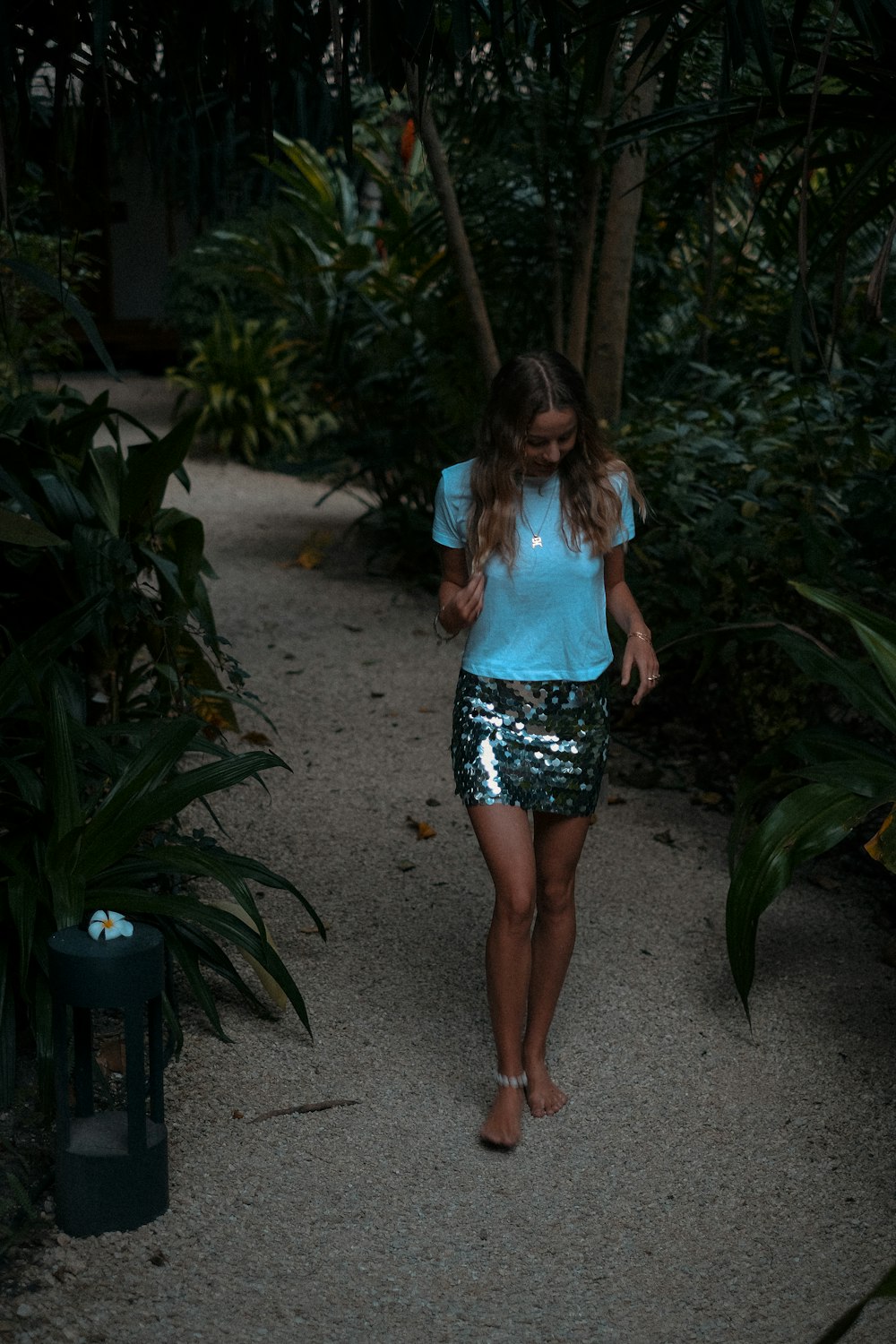 a woman walking on a path in the woods