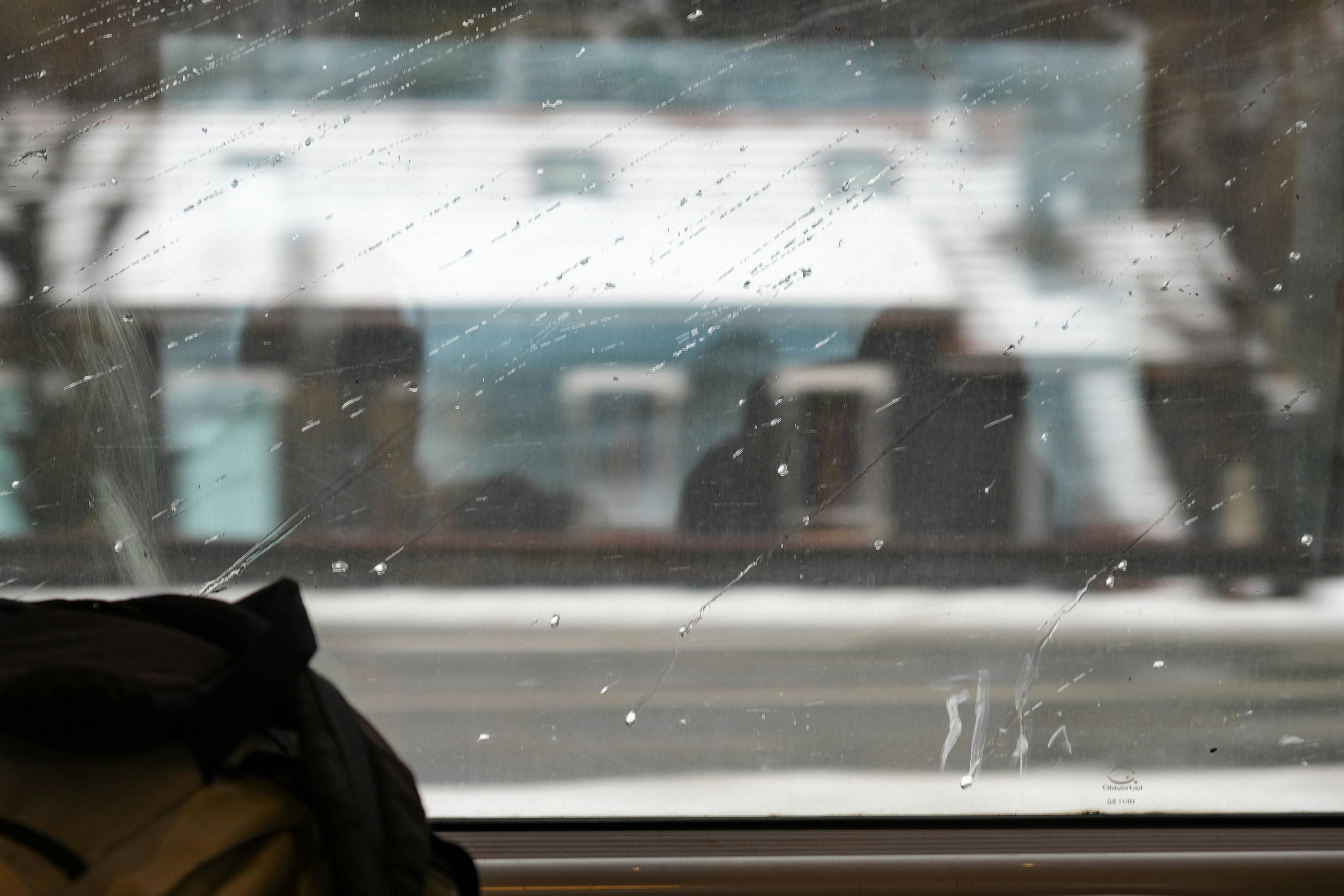 a person relaxing by an indoor pool looking out at a snowy Chicago skyline - Chicago indoor swimming pool