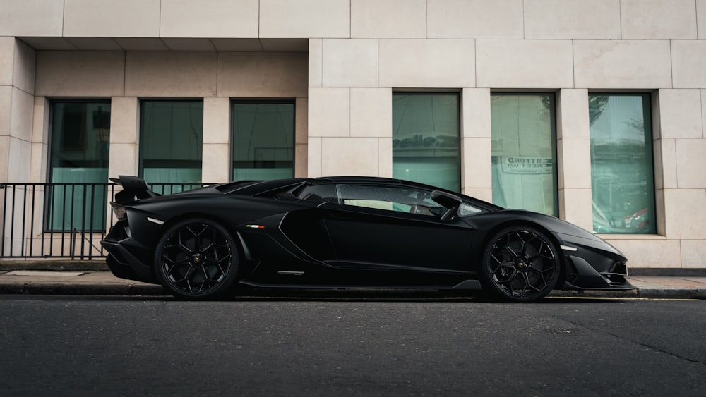 a black sports car parked on the side of a street