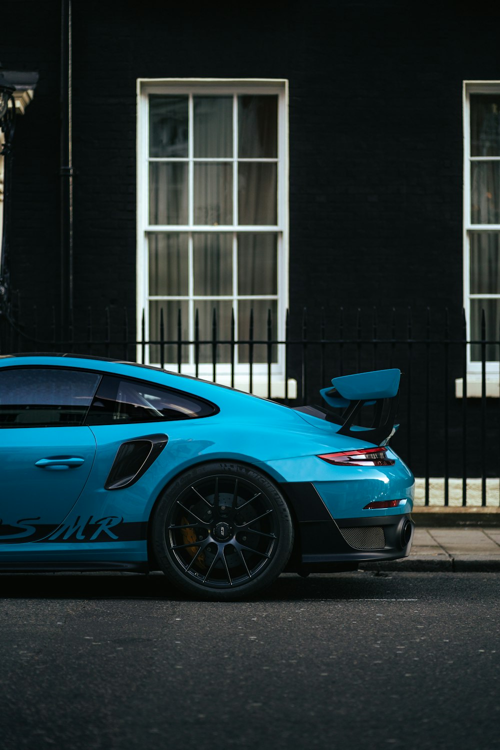 Un coche azul aparcado frente a un edificio