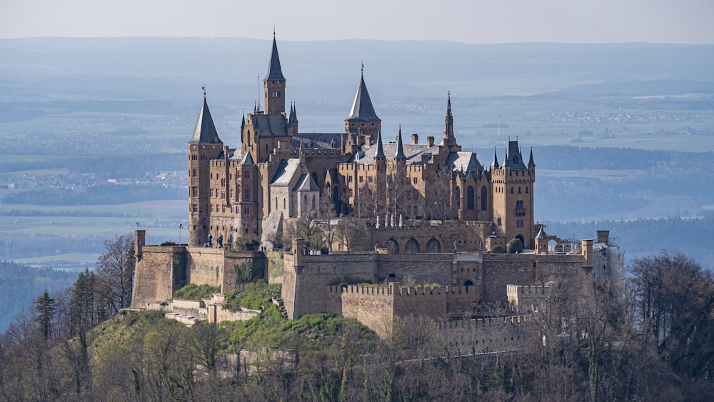 a castle on a hill with Hohenzollern Castle in the background