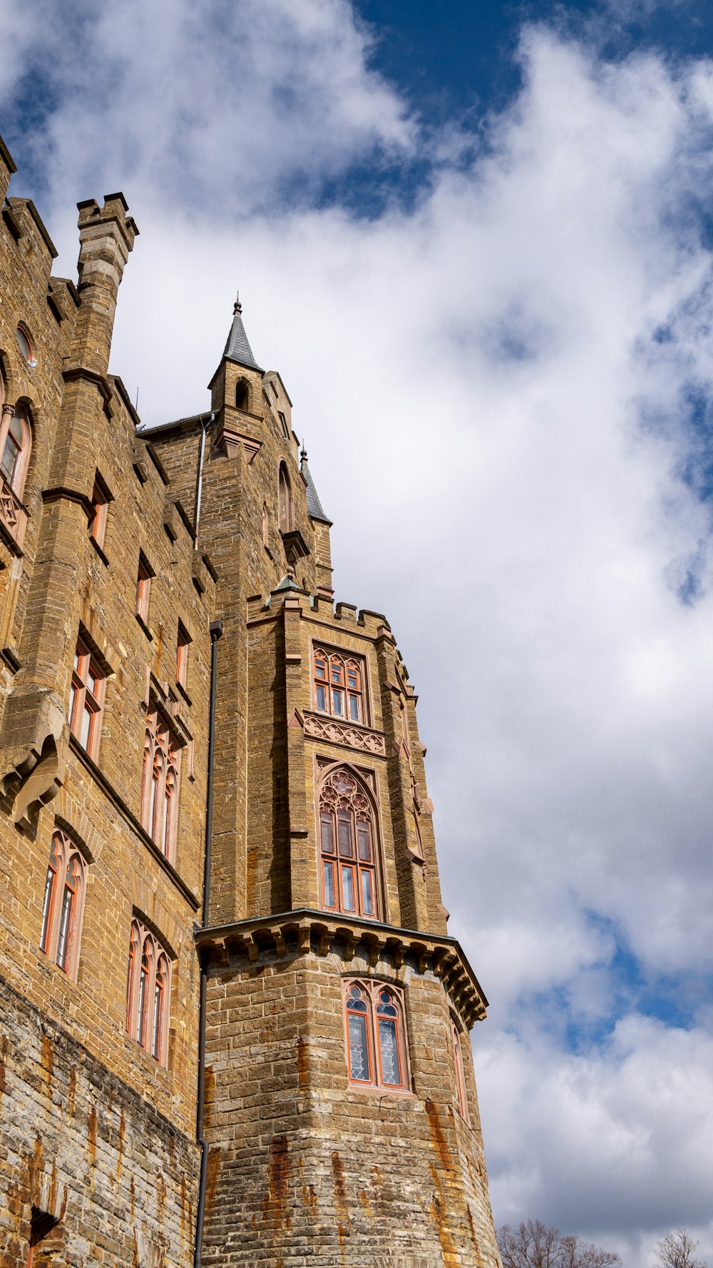 a tall brick building with a cloudy sky