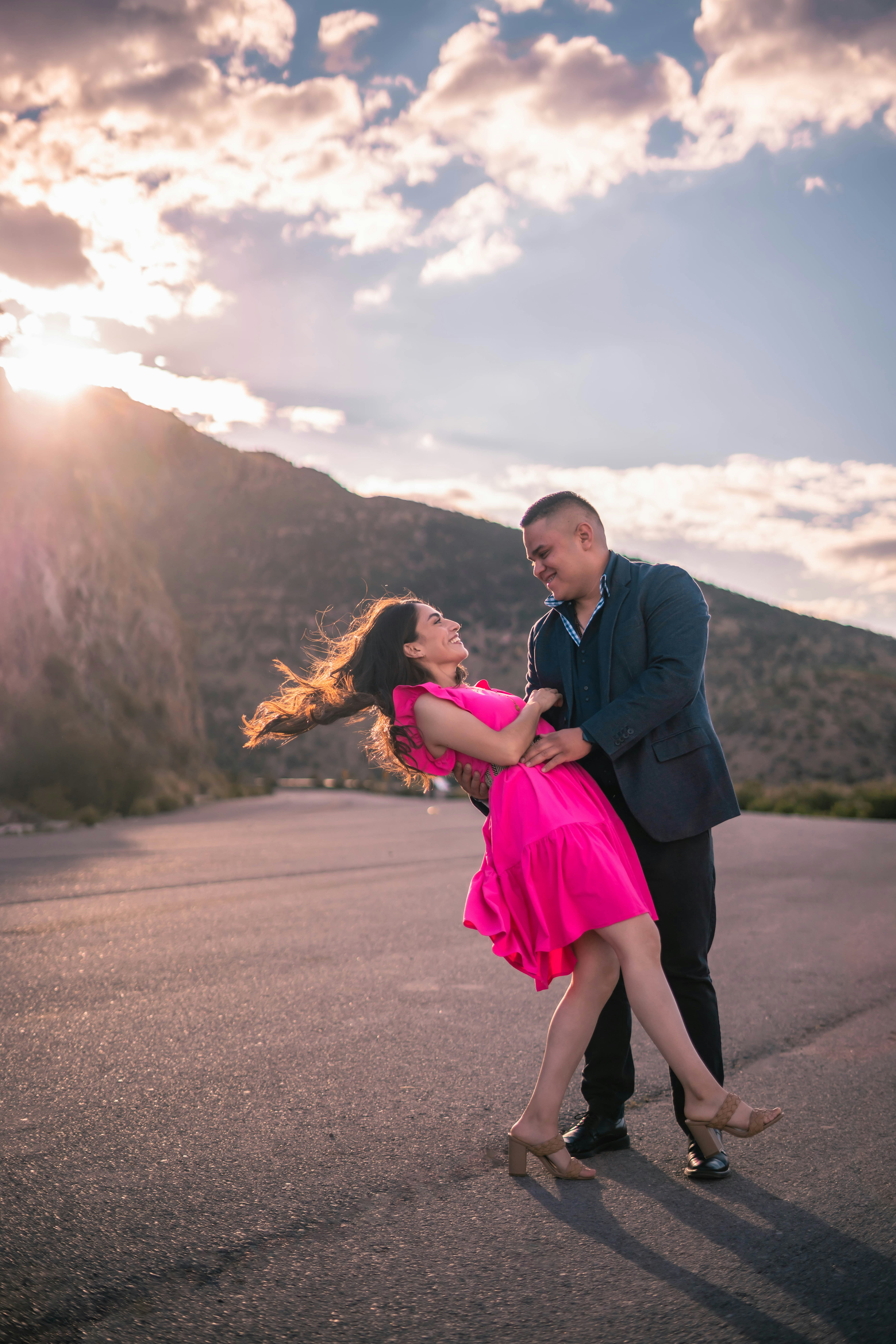 a man and woman holding each other and posing for the camera