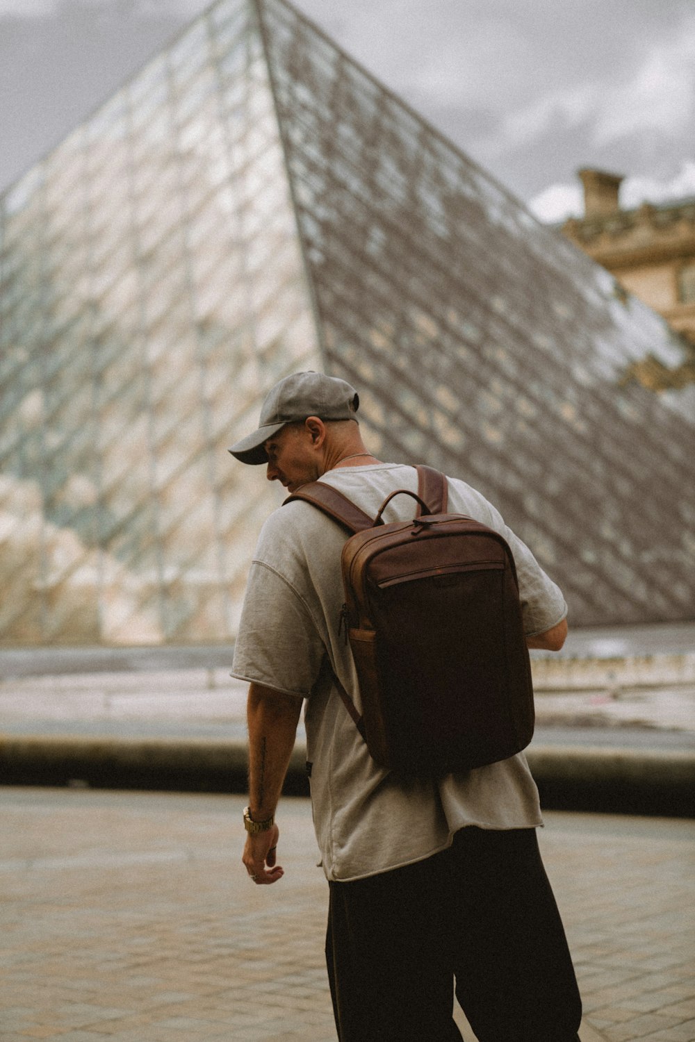 a person walking in front of a pyramid