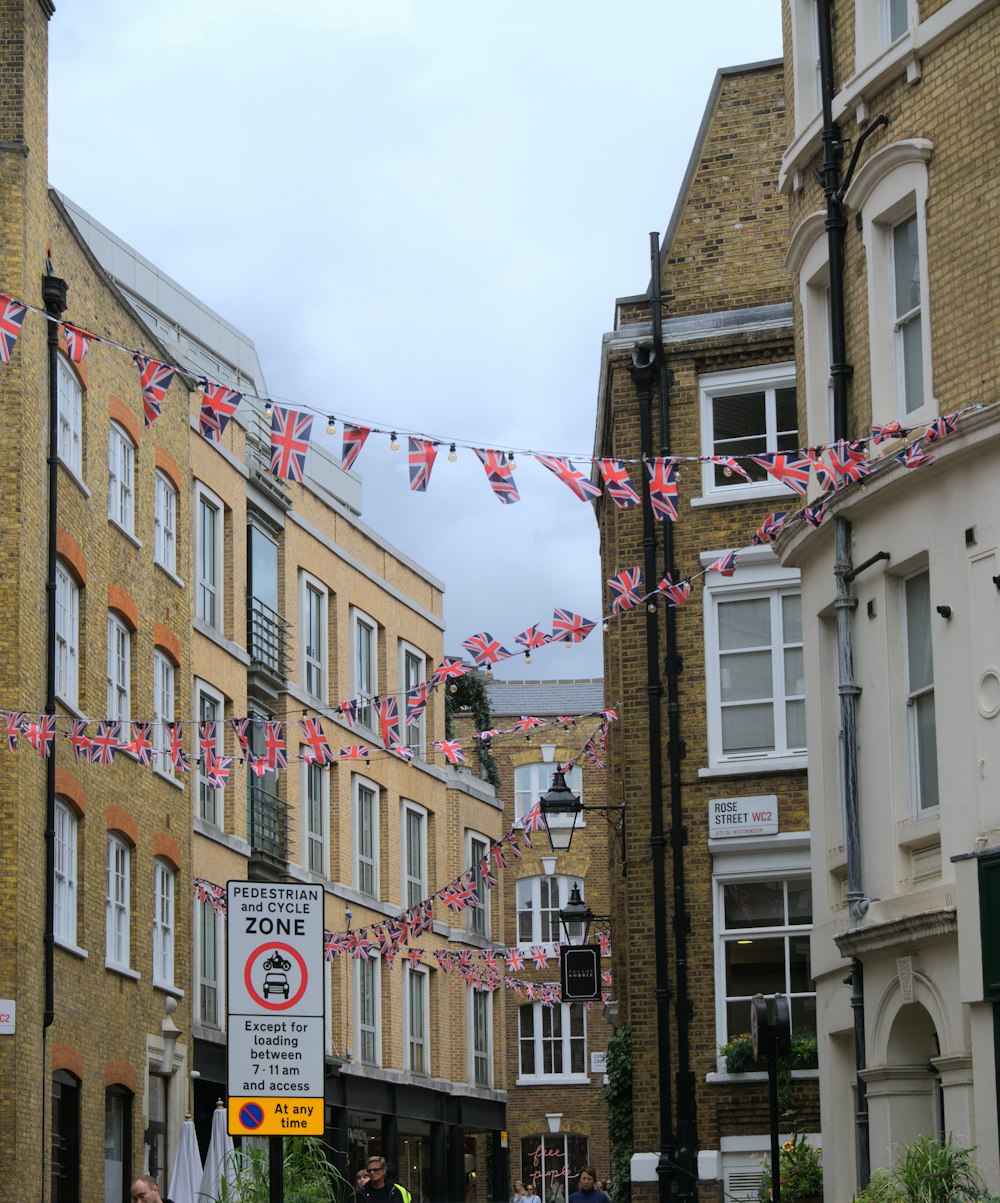 a row of buildings with flags