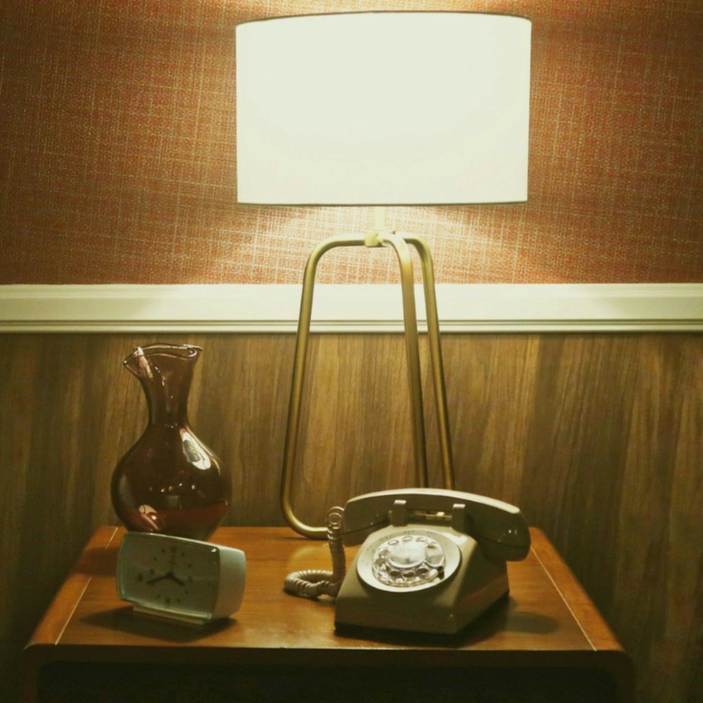 a lamp and a telephone on a table