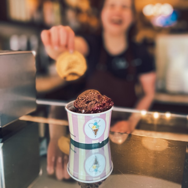 a person sitting at a table with a cup of coffee