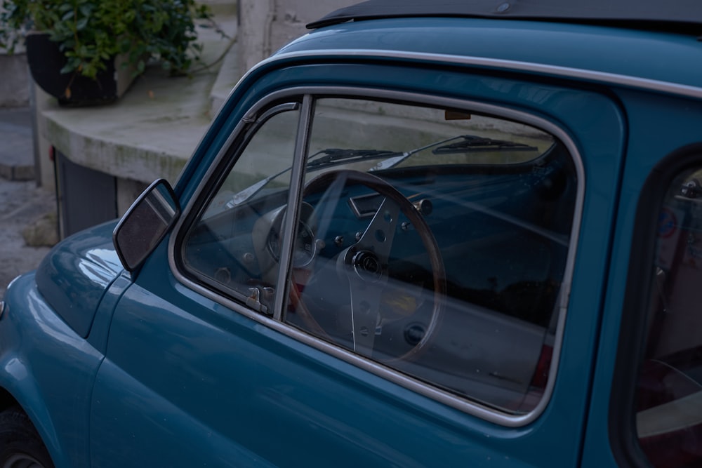 a blue car with a broken window