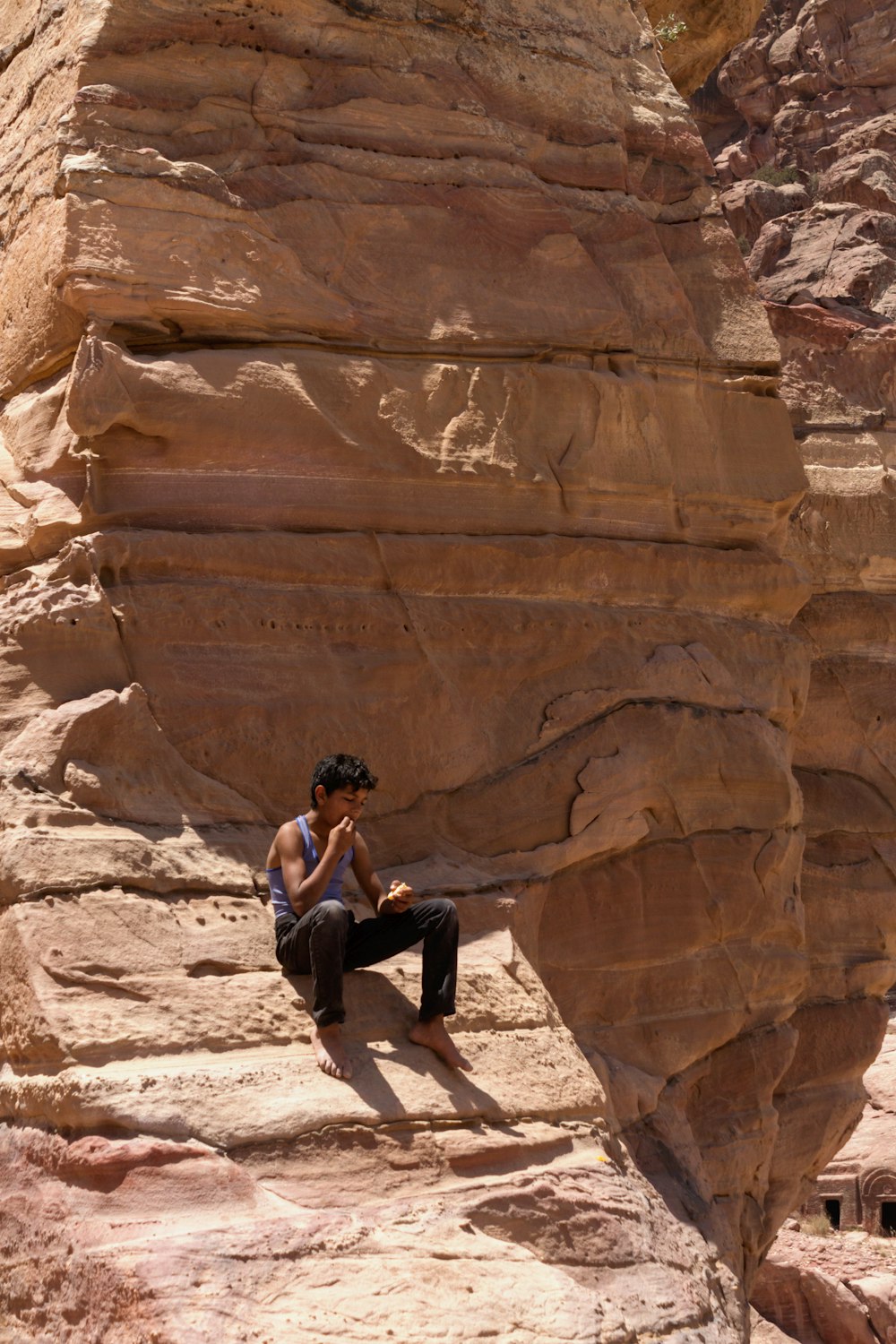 a person sitting in a rock cave