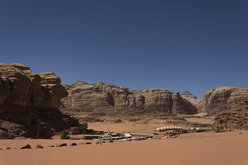 a desert landscape with a few buildings