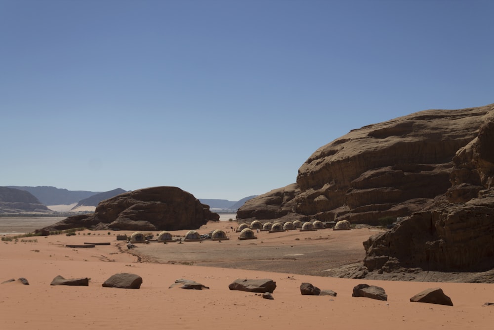 a desert with rocks with Wadi Rum in the background