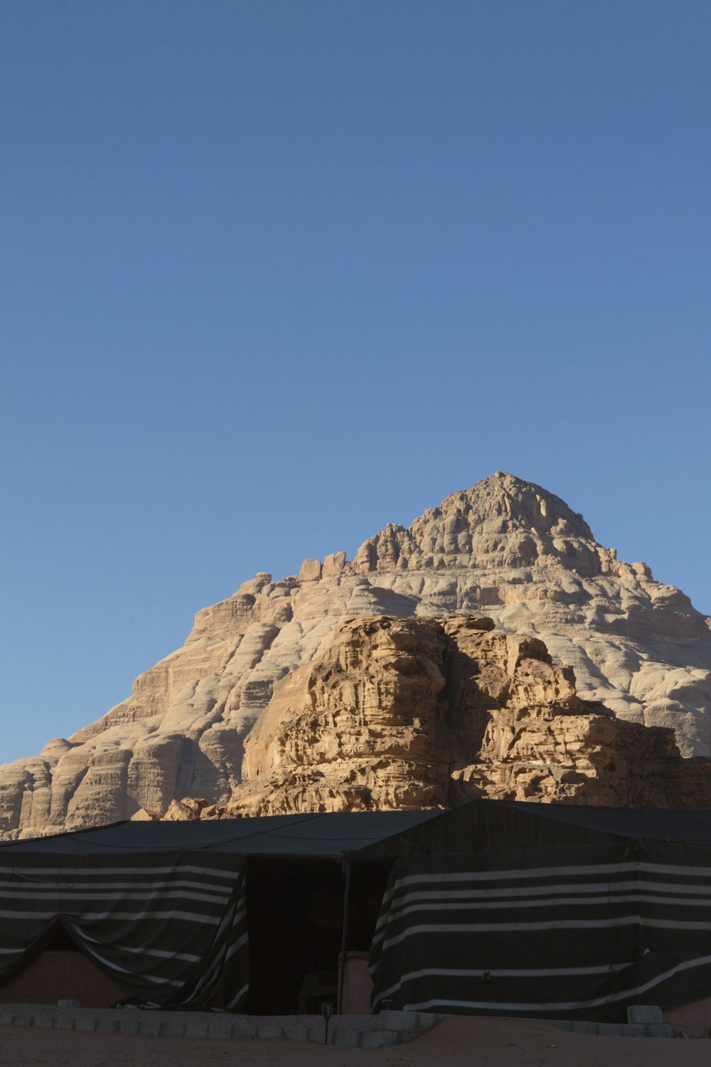 a mountain with a building below