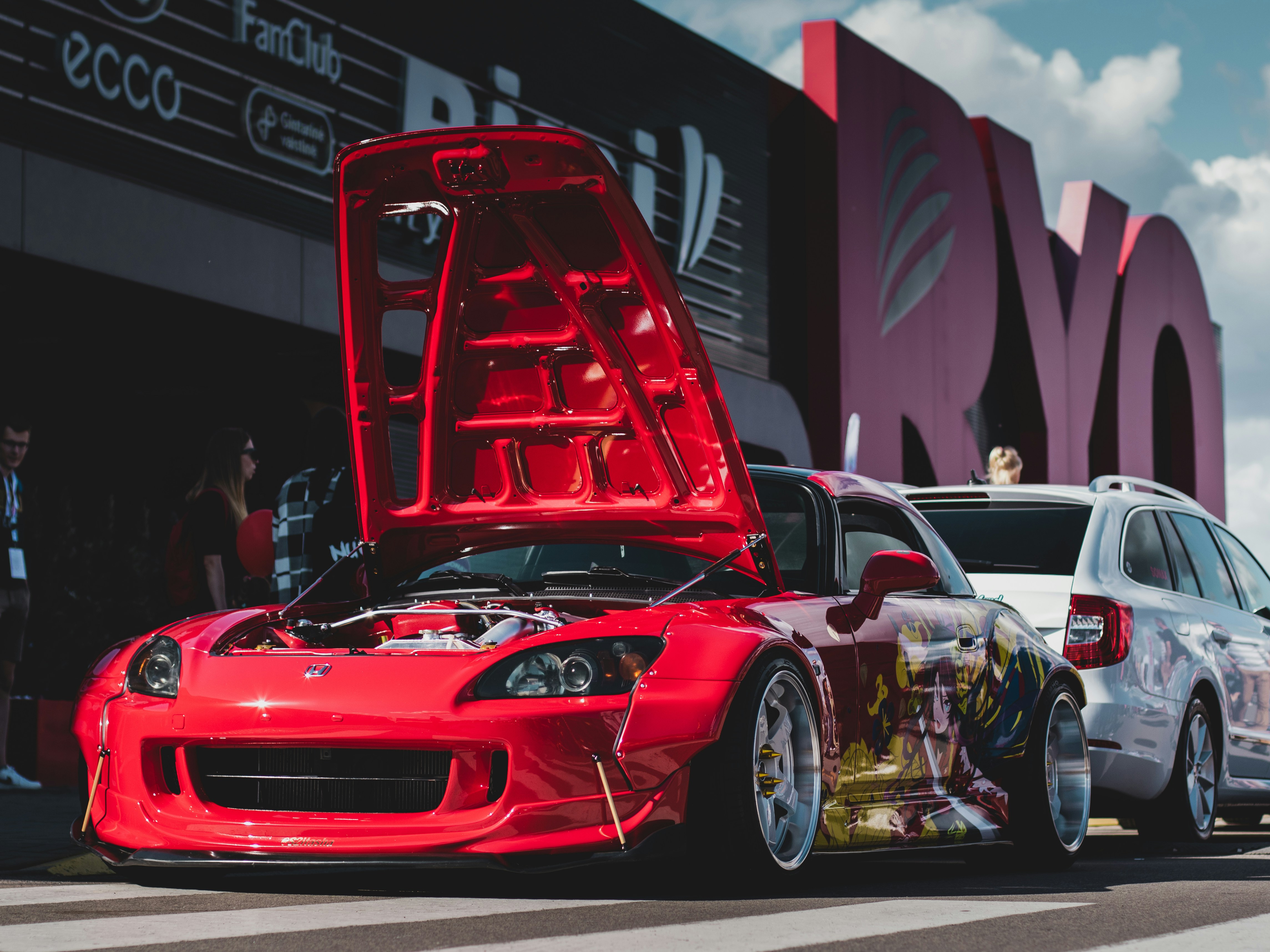 a red car with a large box on top of it