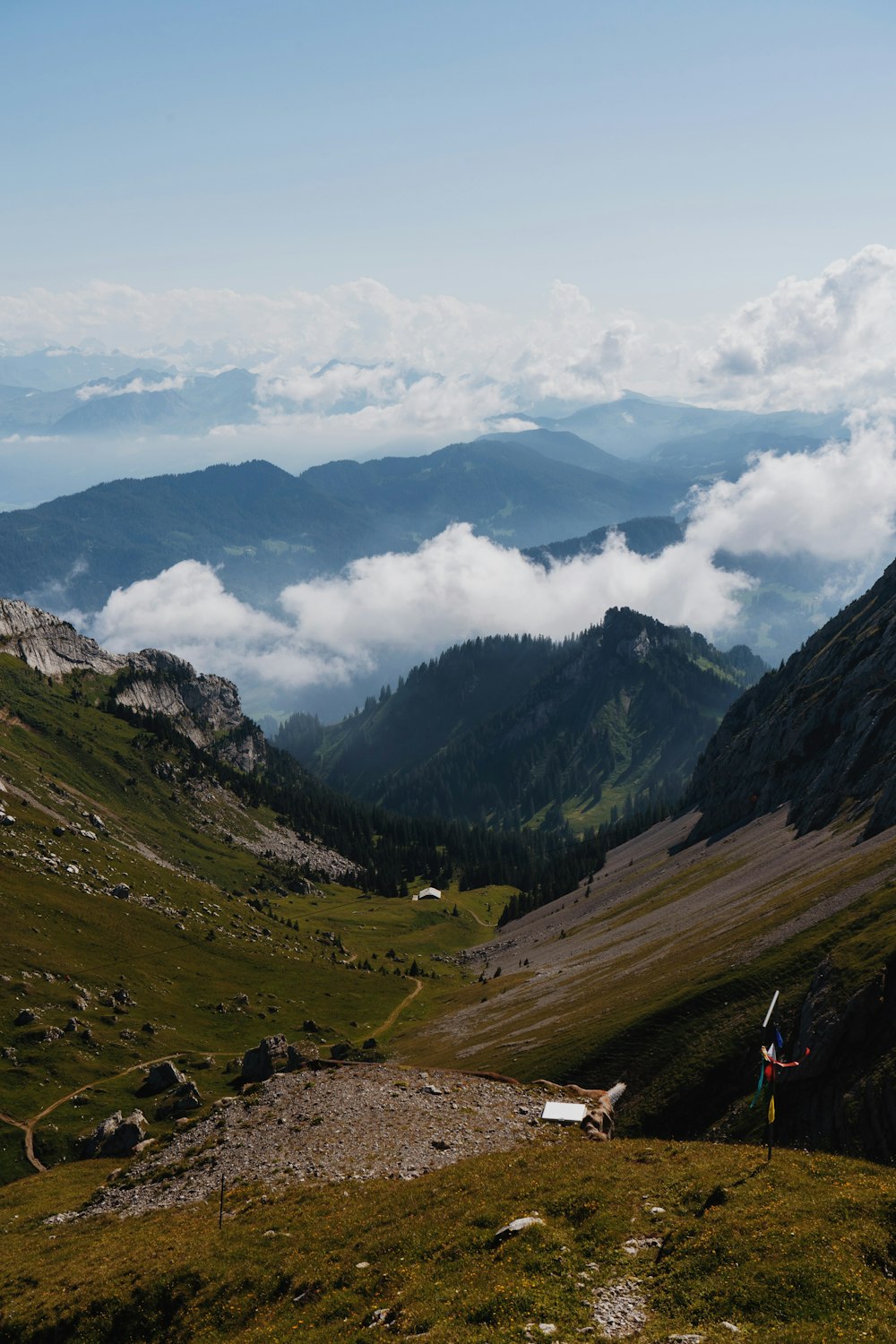 a valley with mountains and clouds