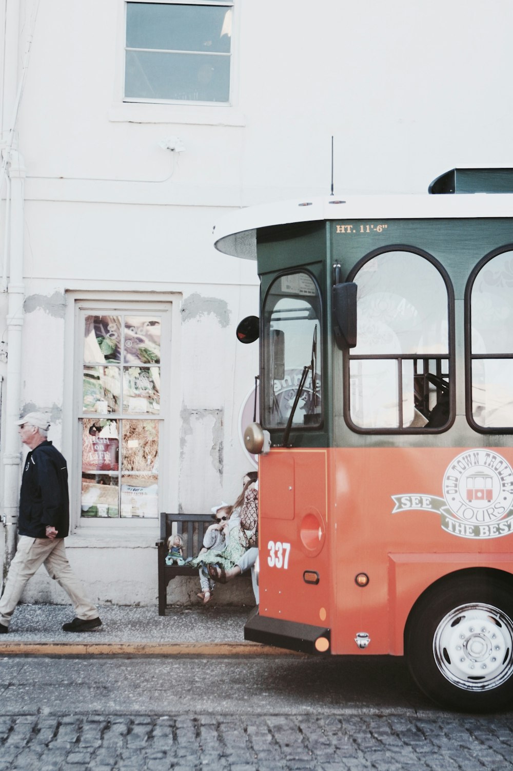 a person walking next to a bus