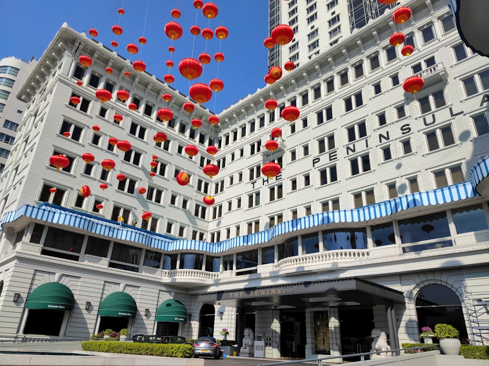 a large cruise ship with many red lanterns from the roof