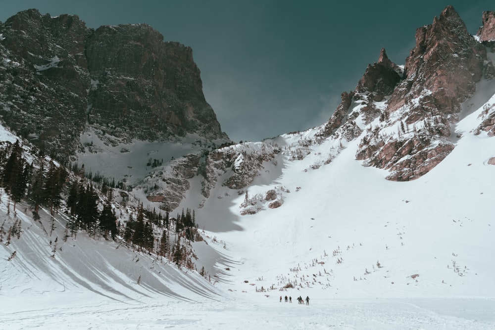 a group of people skiing down a mountain