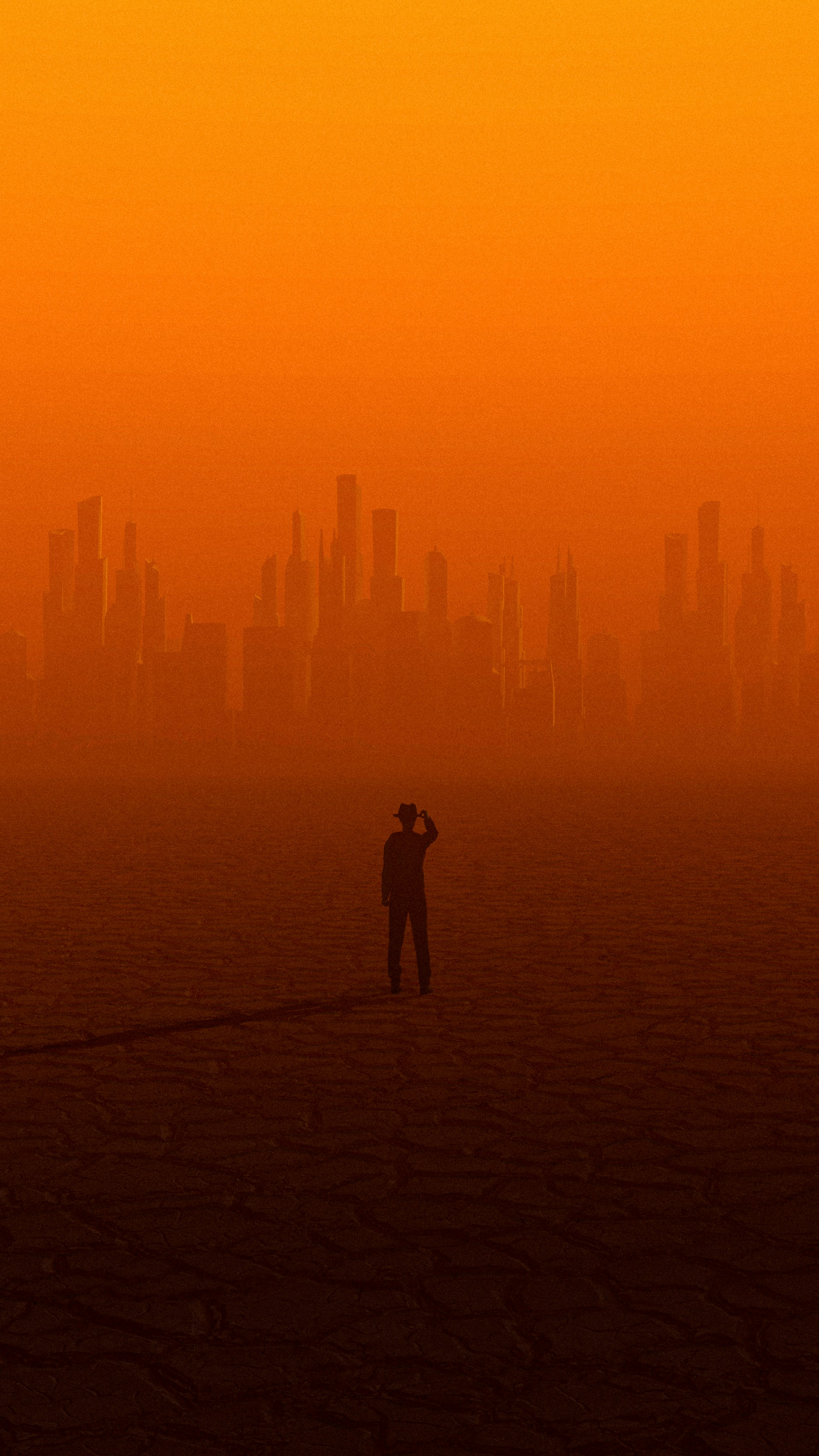 a man and woman kissing on a beach with a city in the background