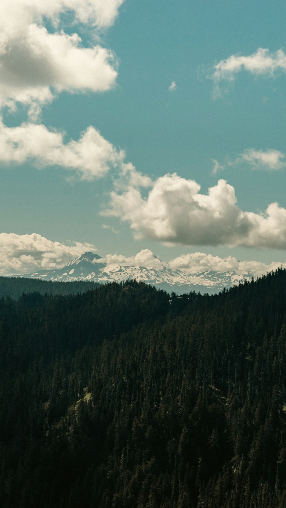 a mountain range with clouds