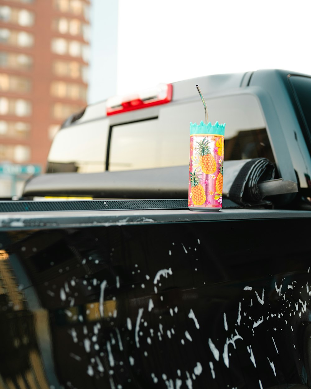 a drink on the hood of a car