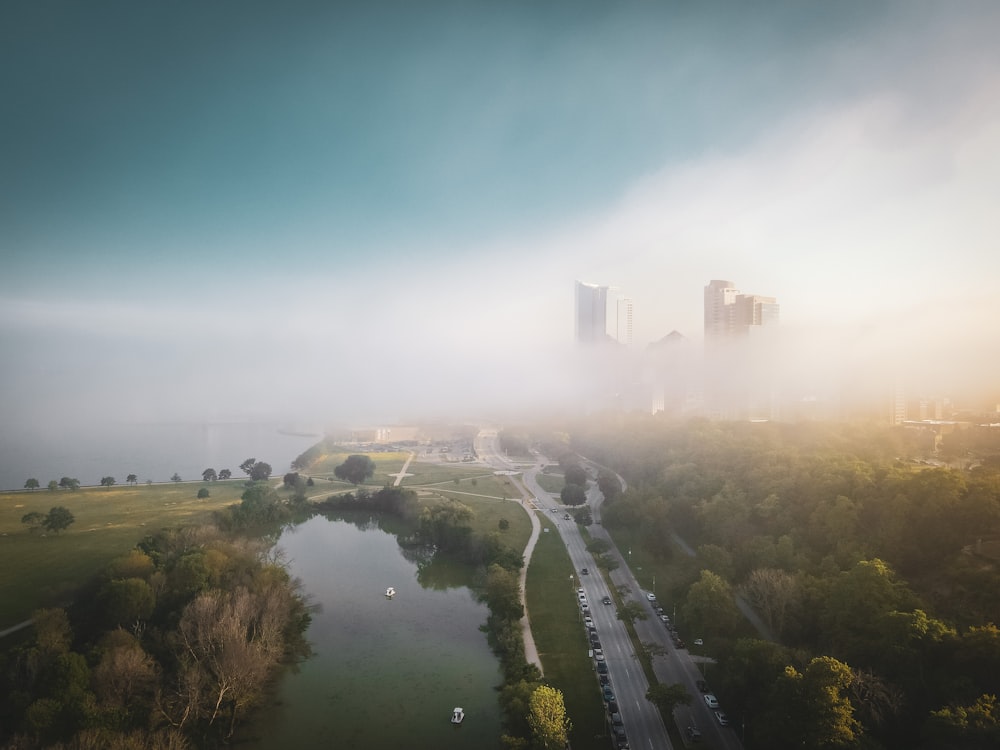 a road with a river and a city in the background