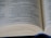 An open book with visible text emphasizing spiritual and moral themes. The focus is on multiple lines of text, likely from a religious or philosophical document.