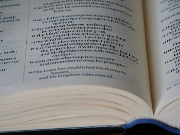 An open book with visible text emphasizing spiritual and moral themes. The focus is on multiple lines of text, likely from a religious or philosophical document.