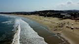 a beach with people and boats