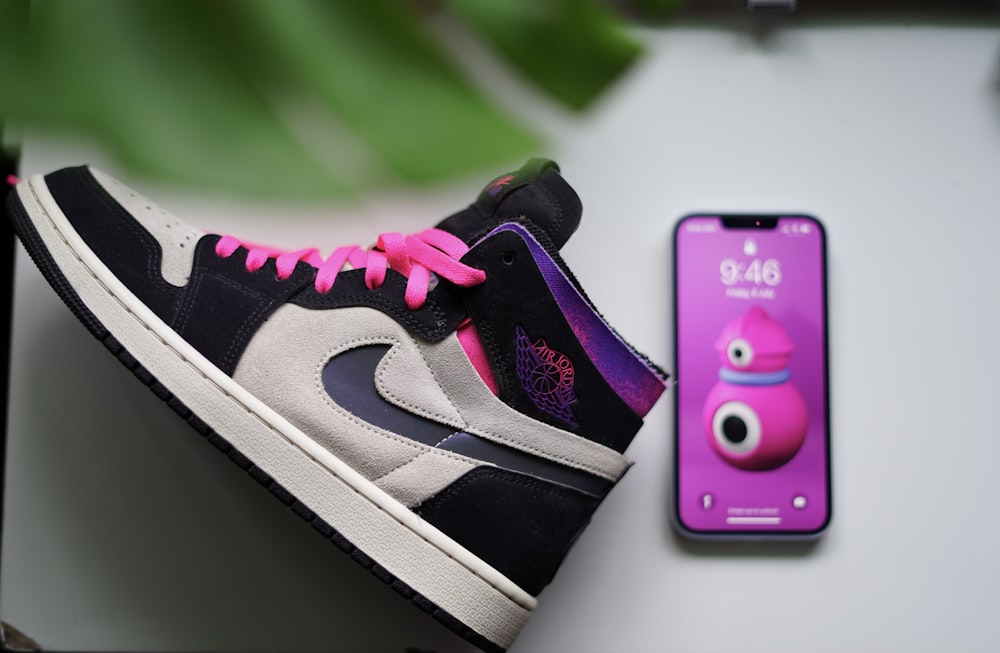 a cell phone next to a shoe