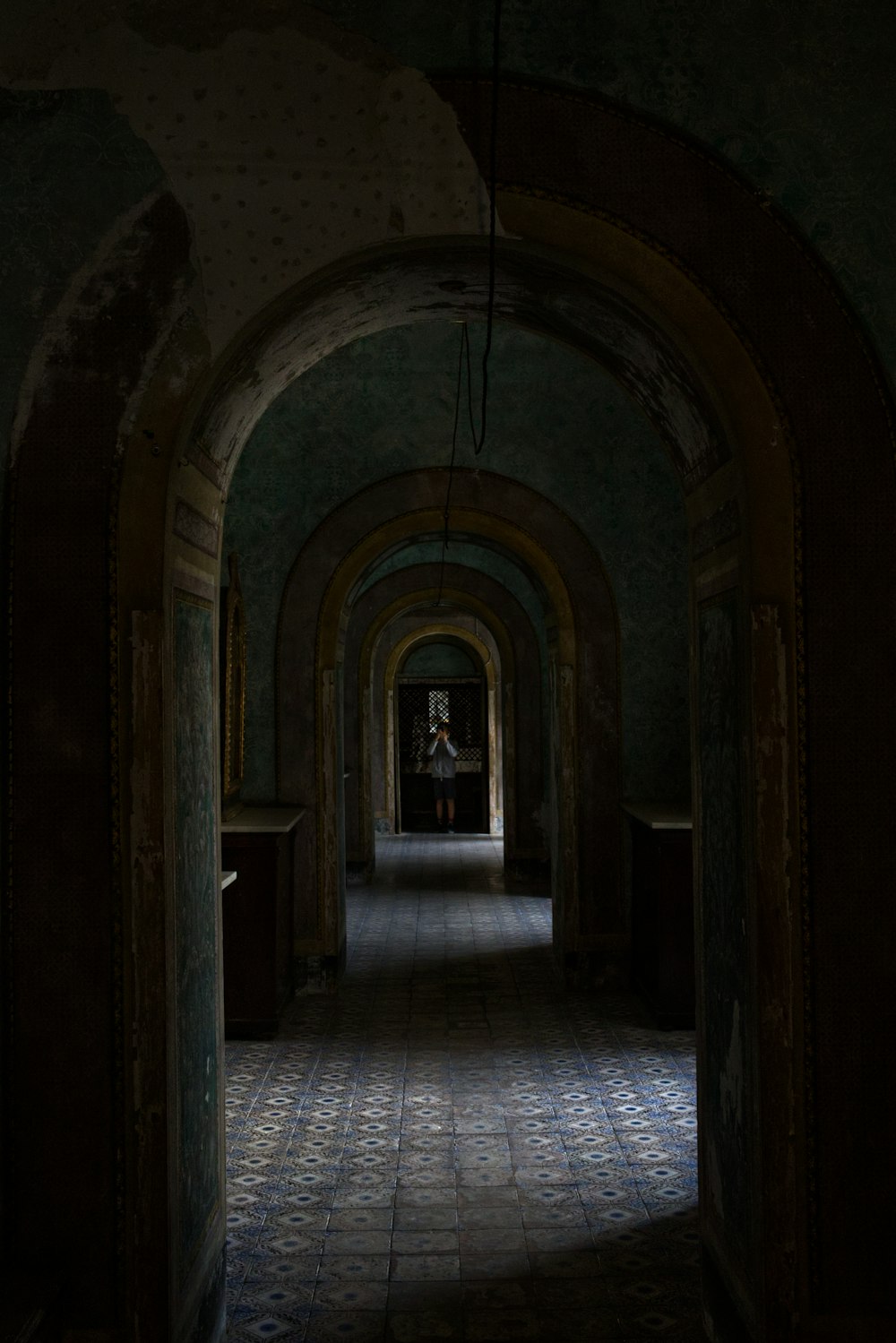 a couple of people walking through a hallway