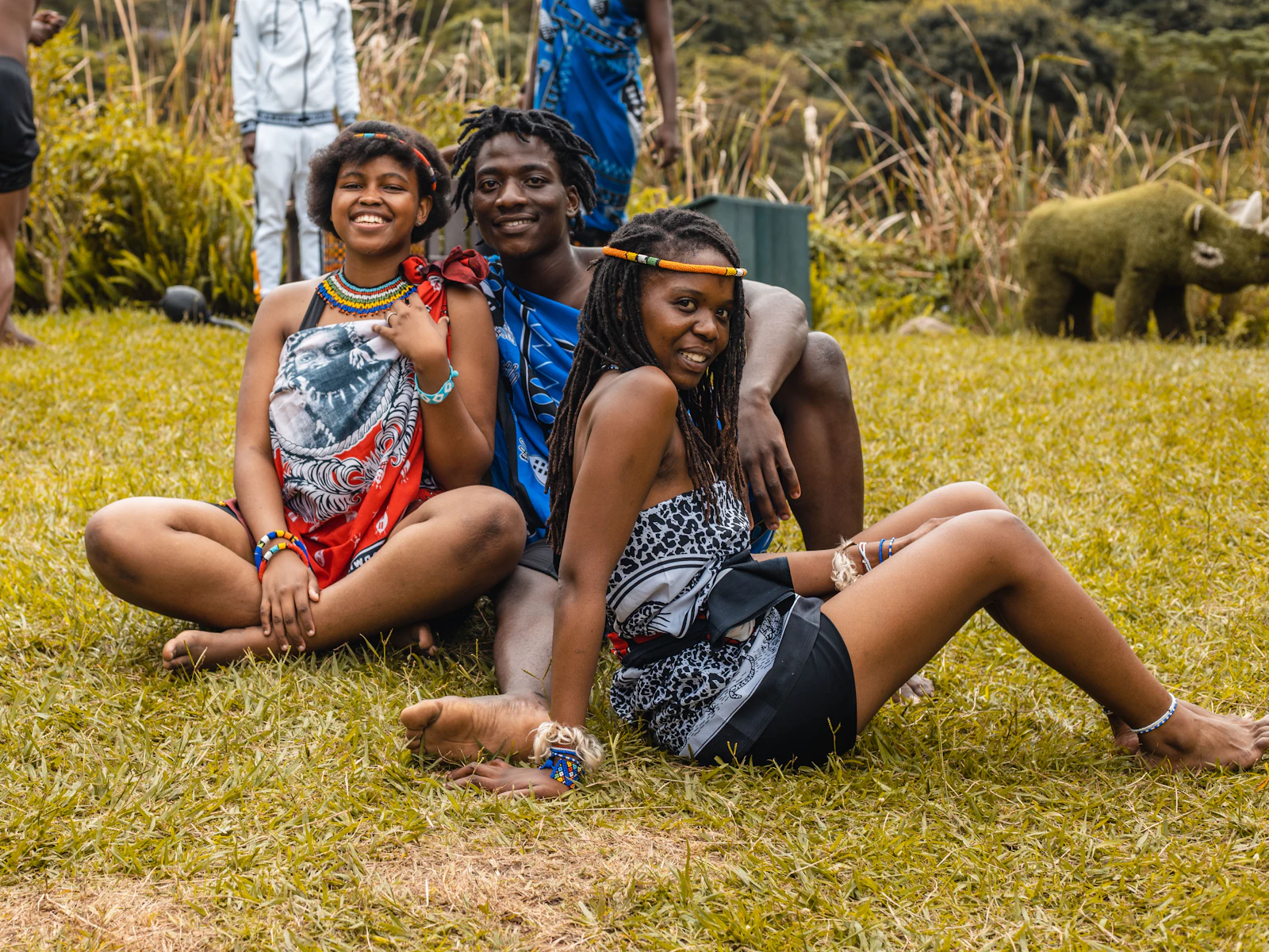 Friends sitting on the grass together at camp