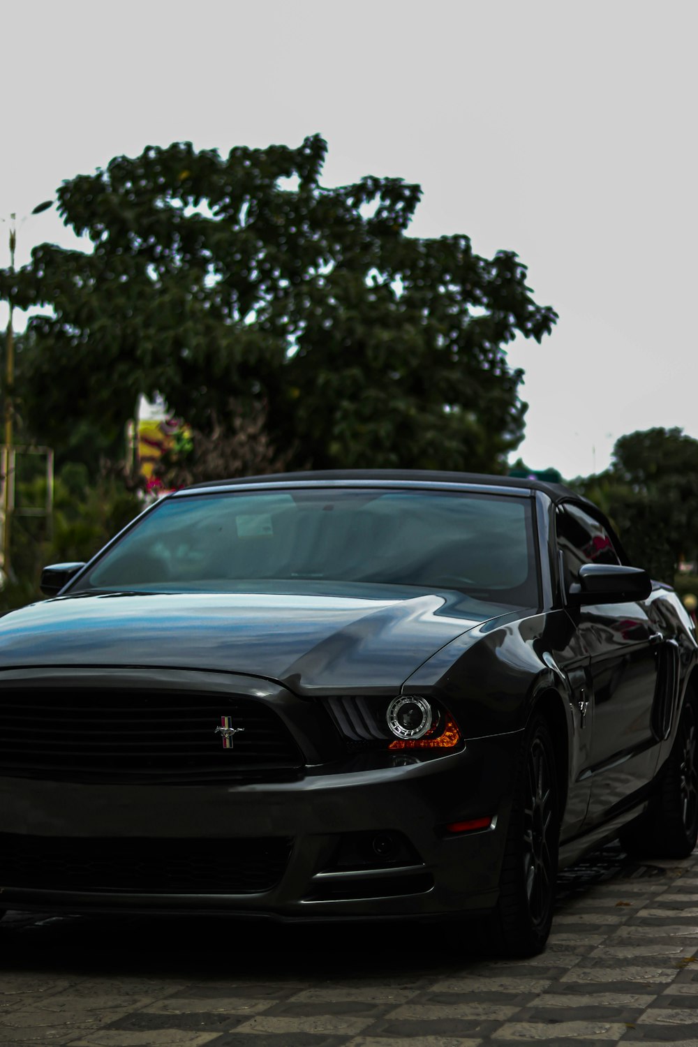 a black car parked on a brick road