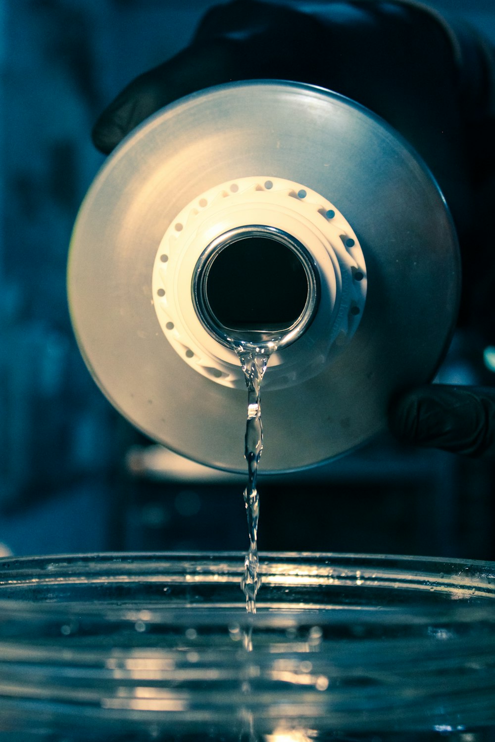 a water droplet falling into a glass of water